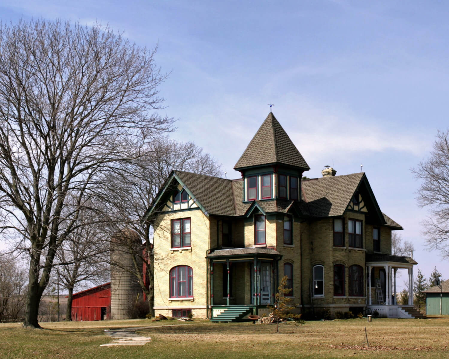 Free Gutter Estimate Pitt Meadows Large historic-style home with tower and porch.
